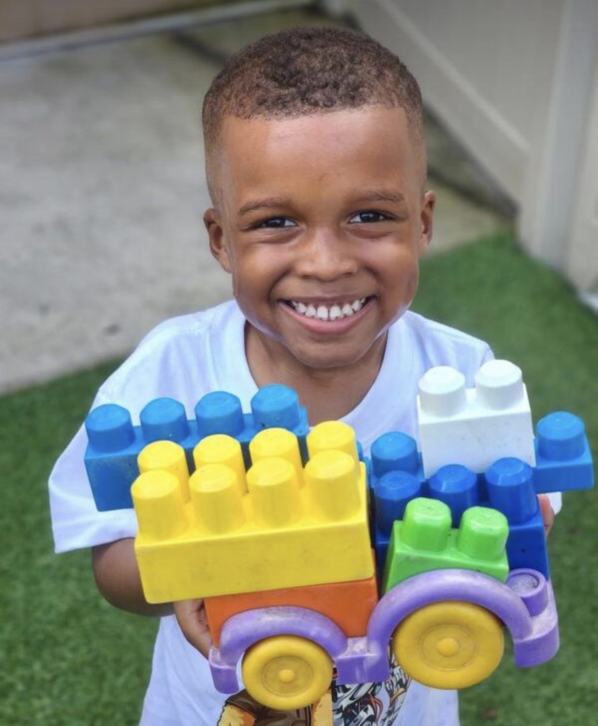 A proud builder showing off his block tower
